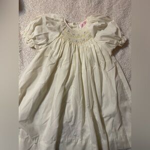 Petit Ami Cream Baby Dress with Pastel Smocking